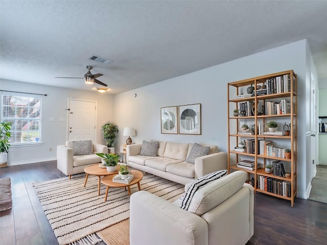 living room featuring dark hardwood / wood-style flooring and ceiling fan