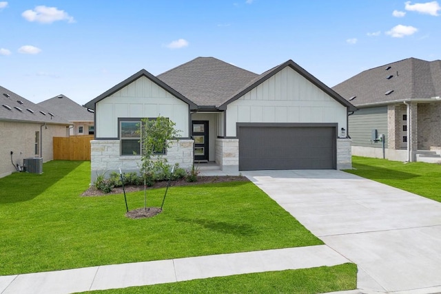 260 Lazy Lizzy Rd, Jarrell, TX 76537 - view of front of home featuring board and batten siding, a garage, stone siding, concrete driveway, and a shingled roof