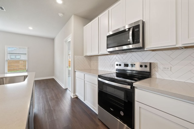 260 Lazy Lizzy Rd, Jarrell, TX 76537 - kitchen with appliances with stainless steel finishes, dark wood-style floors, backsplash, light countertops, and recessed lighting