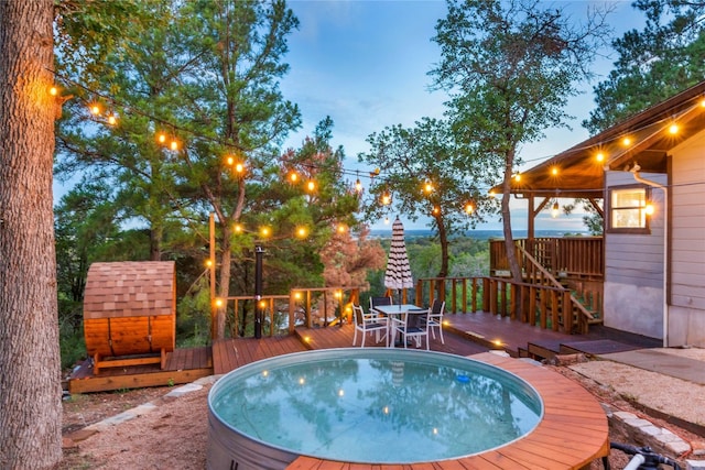 pool at dusk with a deck