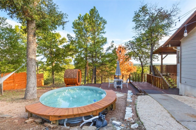 view of swimming pool with a deck