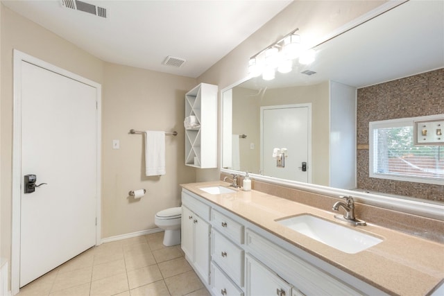 bathroom with tile patterned floors, vanity, and toilet