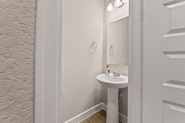 bathroom with hardwood / wood-style floors and sink