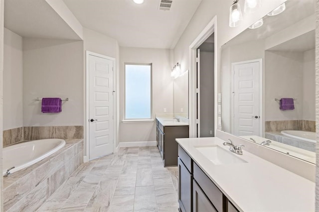 bathroom featuring vanity and tiled bath