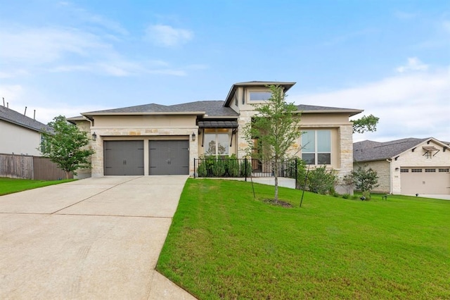 prairie-style home featuring a front lawn and a garage