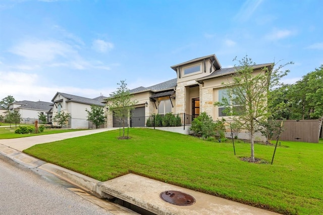 view of front of property with a garage and a front yard