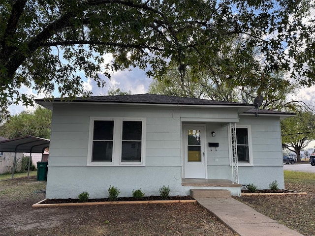 bungalow-style home with a carport