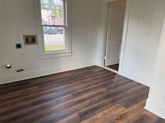 interior space with wooden walls, washer hookup, dark hardwood / wood-style floors, and hookup for an electric dryer