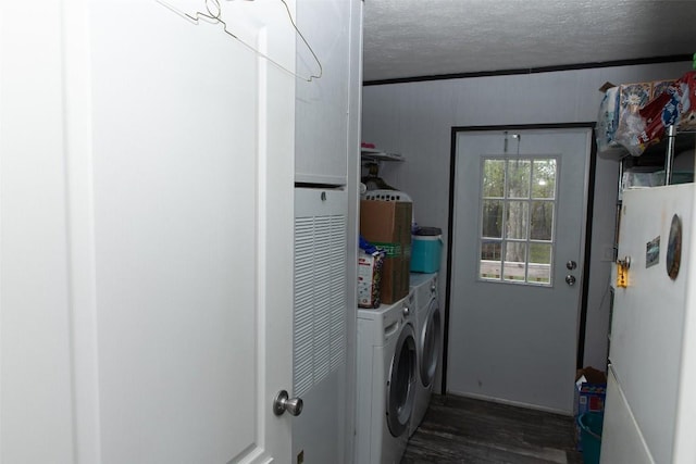 washroom with laundry area, dark wood-style flooring, a textured ceiling, and washer and dryer