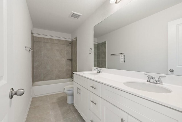 full bathroom featuring tile patterned floors, toilet, vanity, and tiled shower / bath