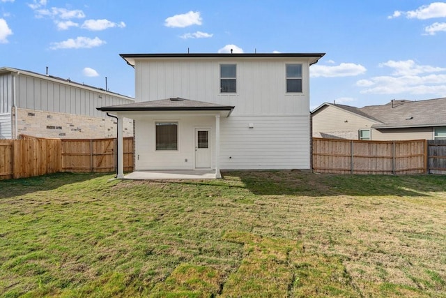 back of house featuring a yard and a patio