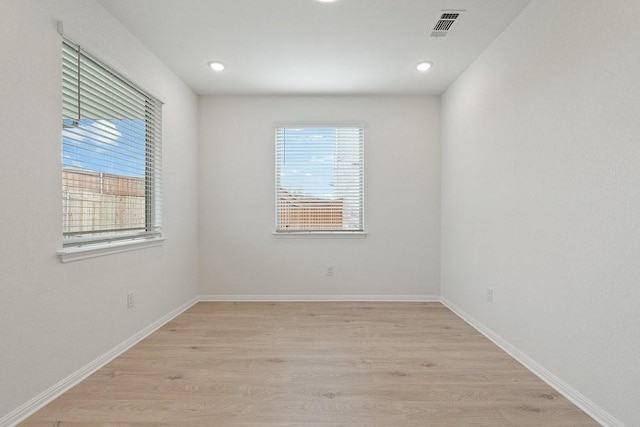 empty room with light hardwood / wood-style flooring