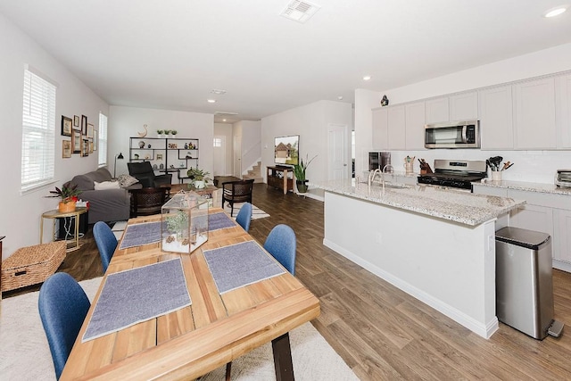 dining area with sink and light wood-type flooring