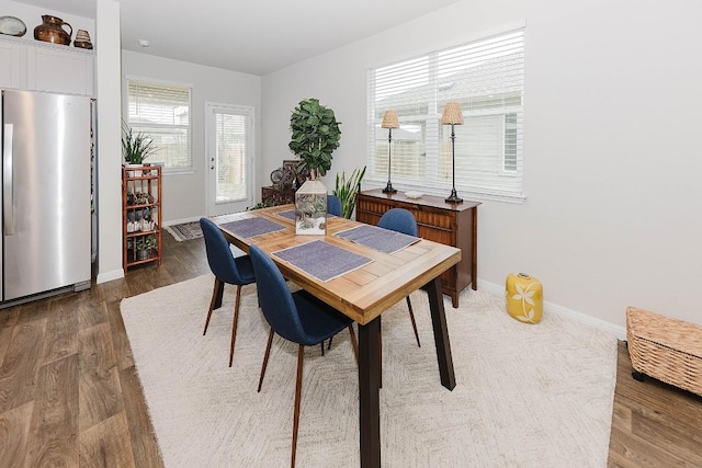 dining room with dark hardwood / wood-style flooring