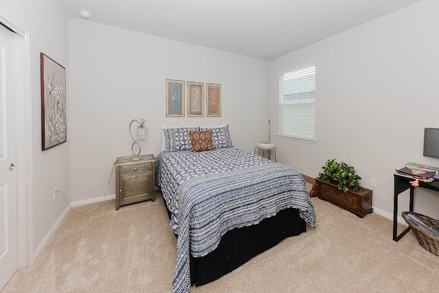 bedroom featuring light carpet