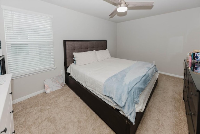 bedroom with light carpet and ceiling fan