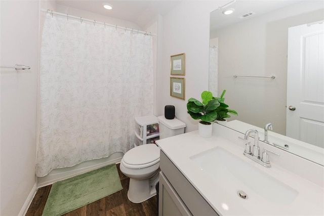 full bathroom with shower / bathtub combination with curtain, vanity, toilet, and hardwood / wood-style floors