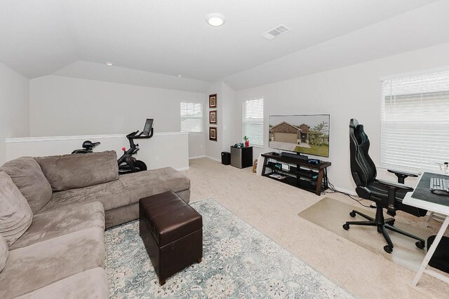 carpeted home office with vaulted ceiling