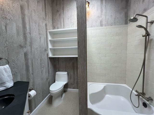 bathroom with tile patterned floors, tiled shower / bath combo, toilet, and wooden walls