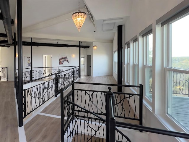 hallway featuring hardwood / wood-style flooring and an inviting chandelier