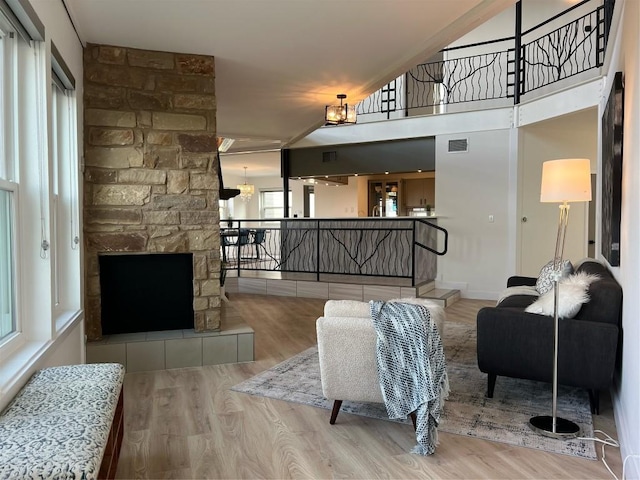 living room with a fireplace and light wood-type flooring