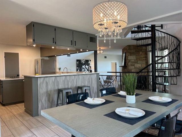 dining room with an inviting chandelier and sink