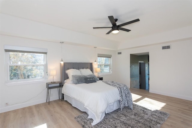 bedroom with light hardwood / wood-style flooring, multiple windows, and ceiling fan