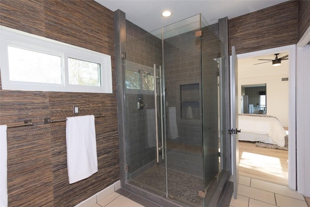 bathroom featuring tile patterned floors, ceiling fan, and an enclosed shower