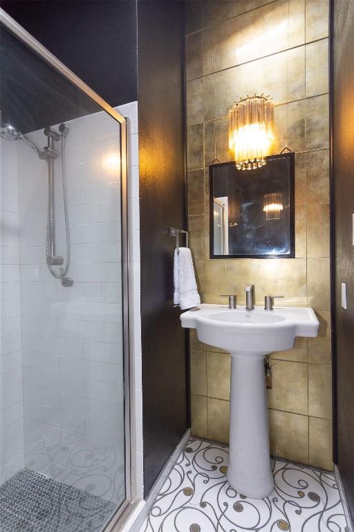 bathroom featuring tile walls, tile patterned flooring, and an enclosed shower