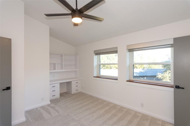 unfurnished bedroom with ceiling fan, lofted ceiling, and light carpet