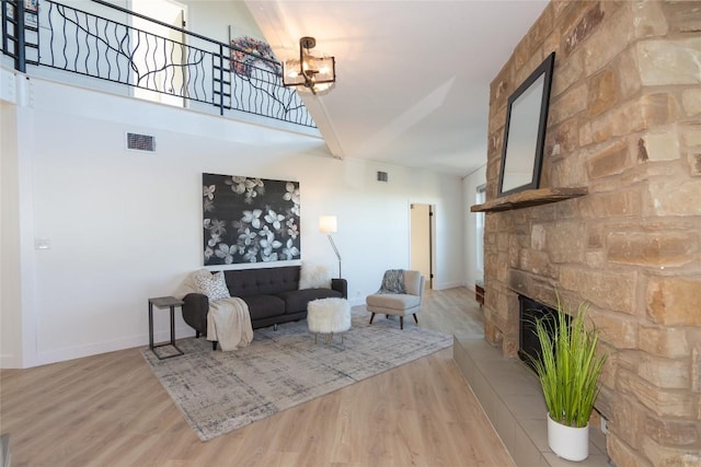 living room with a fireplace and light hardwood / wood-style flooring