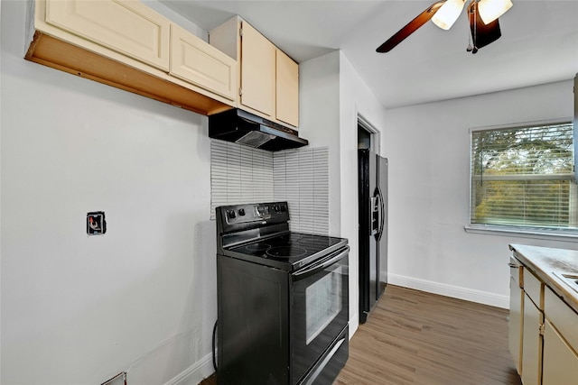 kitchen featuring ceiling fan, dark hardwood / wood-style flooring, black appliances, and cream cabinetry