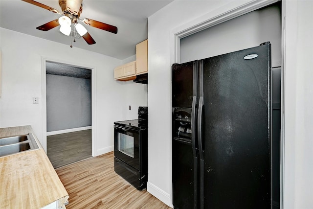 kitchen with ceiling fan, sink, extractor fan, light hardwood / wood-style floors, and black appliances