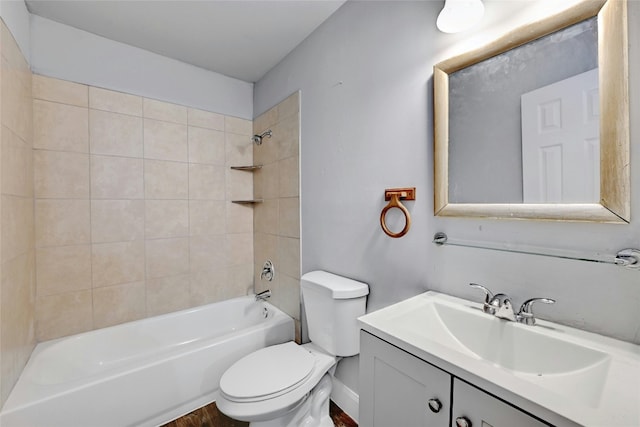 full bathroom with vanity, hardwood / wood-style flooring, toilet, and tiled shower / bath