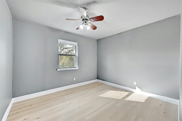 spare room featuring light hardwood / wood-style flooring and ceiling fan