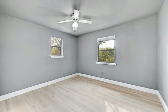 unfurnished room with light hardwood / wood-style flooring, plenty of natural light, and ceiling fan