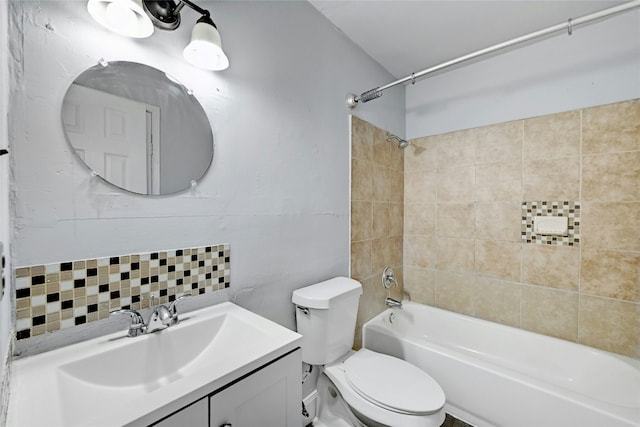 full bathroom featuring decorative backsplash, toilet, tiled shower / bath, and vanity