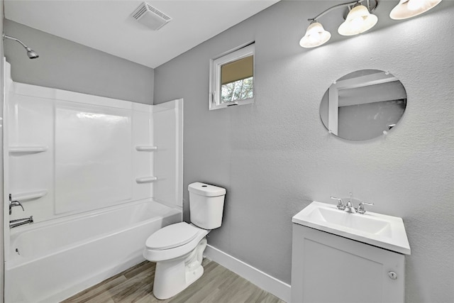 full bathroom featuring hardwood / wood-style floors, vanity, shower / bath combination, and toilet