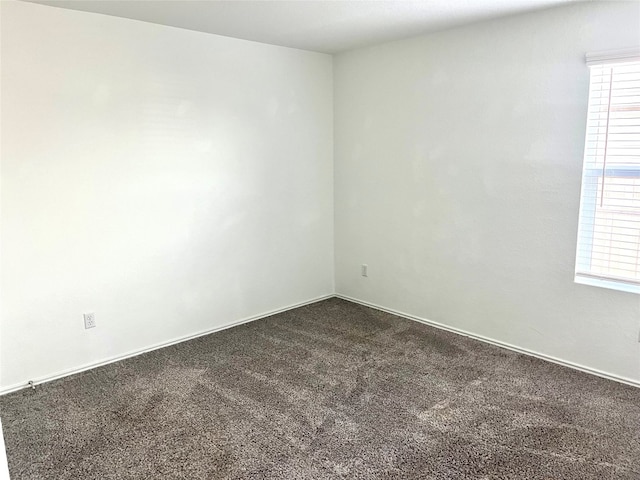 empty room featuring dark colored carpet