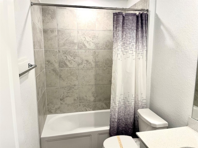 full bathroom with shower / bath combo, vanity, and toilet