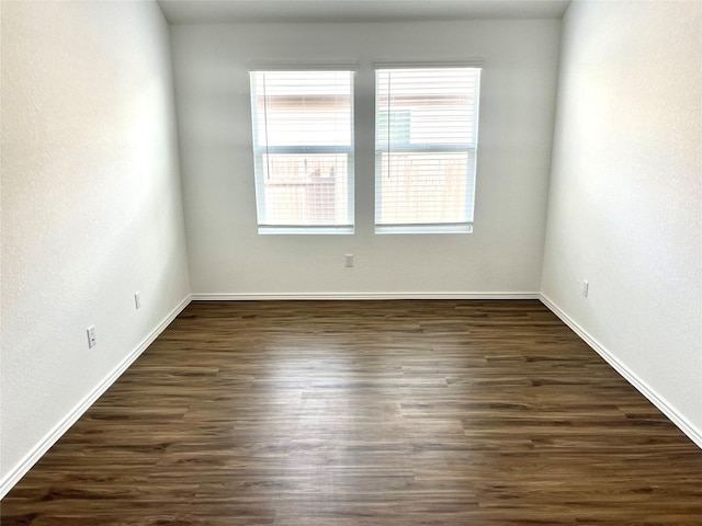 unfurnished room featuring dark hardwood / wood-style flooring