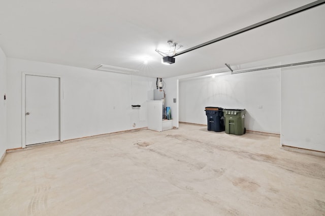 garage featuring a garage door opener and water heater