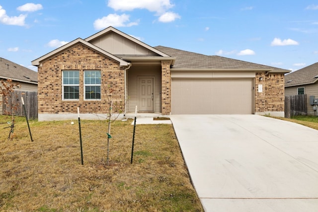 ranch-style house with a garage and a front yard