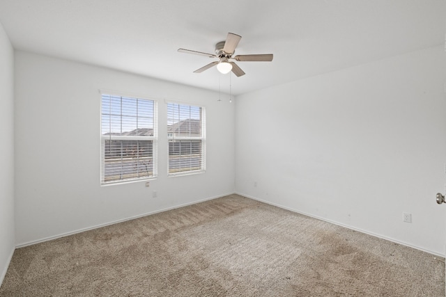 spare room with carpet floors and ceiling fan