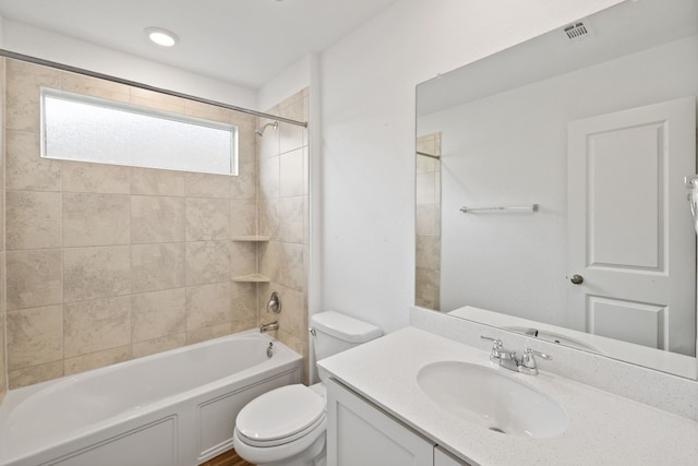 full bathroom featuring vanity, toilet, and tiled shower / bath