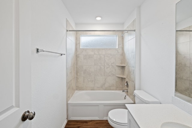 full bathroom featuring toilet, vanity, tiled shower / bath combo, and hardwood / wood-style flooring