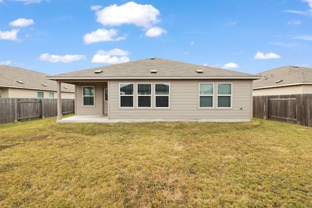 back of property featuring a yard and a patio