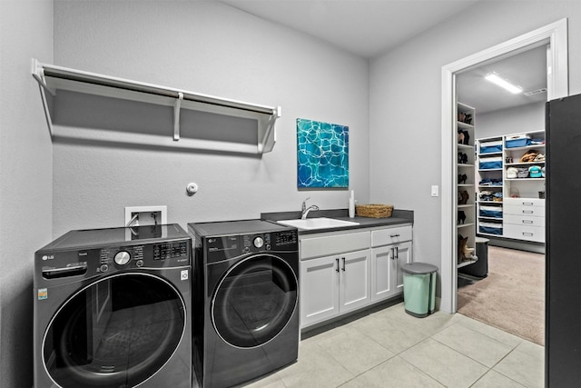 laundry area with cabinets, washing machine and dryer, sink, and light colored carpet