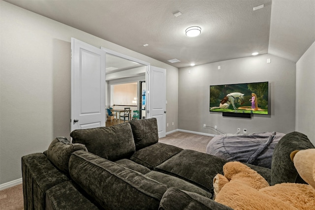 carpeted cinema with lofted ceiling and a textured ceiling