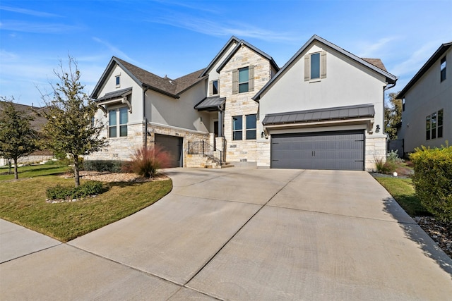 view of front of home with a garage and a front lawn